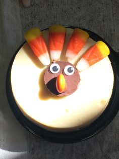 a cake decorated to look like a turkey with candy sticks sticking out of it's head