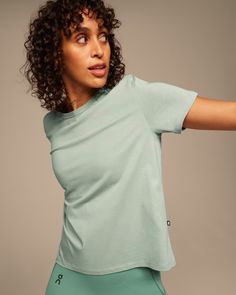 Women's On-T | Moss | On United States Fitted T-shirt For Yoga In Spring, Moisture-wicking Stretch Cotton T-shirt, Comfortable Fitted Tops For Loungewear, Comfortable Fitted Loungewear Tops, Sporty Organic Cotton T-shirt For Spring, Cotton Short Sleeve Activewear For Loungewear, Comfortable Everyday Fitted Tops, Comfortable Fitted Tops For Everyday, Comfortable Stretch T-shirt For Spring