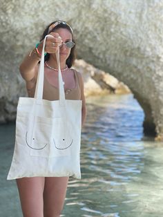 Canvas bag with pocket with decorative pattern. Handmade in Montreal. 100% cotton 100% reusable Tote bag with a design pocket in front. Made by hand in Montreal. 100% cotton 100% reusable Maintenance Guide: This bag should be washed upside down at the delicate cycle in the washing machine. Care Guide: This bag should be wash upside down at a delicate cycle in the washing machine. Summer Cotton Shoulder Bag With Pockets, Cotton Beach Bag With Pockets For Travel, Eco-friendly Cotton Shoulder Beach Bag, Cotton Shoulder Beach Bag For Everyday Use, Cotton Canvas Bag With Silt Pocket For Everyday, Cotton Beach Bag With Pockets For Everyday Use, Cotton Canvas Shoulder Bag For Beach, Cotton Shoulder Beach Bag, Beach Cotton Bags With Pockets