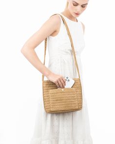 A women's designer crossbody bag for sale online of woven raffia with top zipper closure is super cute for use throughout spring-summer months. The textured weave is intricate with its long strap extending down the sides of the bag body. The mid-size rectangular shape is soft and squishy and feels body friendly. A roomy outer pocket on reverse is for easy access to phone or glasses. Inside: durable cotton canvas lining, sidewall zipper compartment and roomy patch pocket. Dimensions: Front and ba Rectangular Natural Bucket Bag With Intrecciato Weave, Beige Rectangular Straw Bag With Intrecciato Weave, Beige Bucket Bag With Intrecciato Weave For Vacation, Rectangular Bucket Bag With Intrecciato Weave For Vacation, Spring Travel Crossbody Straw Bag, Rectangular Intrecciato Weave Bucket Bag For Vacation, Square Shoulder Bag With Intrecciato Weave For Travel, Chic Woven Bucket Bag, Chic Woven Rectangular Bucket Bag