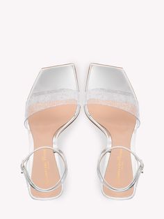 Odyssey silver sandals. They feature Plexi upper, patent leather straps with adjustable Ribbon buckle, graphic design heel and square toe. Heel height: 10,5cm Size nationality: ITA Product number: 33664103 Product code: G3210515PLEPGMSILVER Composition: 50% plexi, 50% calfskin Luxury Silver Heels With Buckle Closure, Glamorous Sandals With Clear Ankle Strap, Formal Silver Sandals With Clear Strap, Evening Sandals With Sculpted Heel And Double Strap, Evening Double Strap Sandals With Sculpted Heel, Evening Silver Sandals With Clear Strap, Silver Sandals With Clear Strap For Party, Silver Sandals With Clear Strap For Evening, Chic Evening Sandals With Transparent Straps