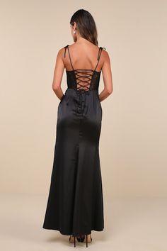 Enchant everyone you meet the moment they see you in the Lulus Spellbinding Aura Black Satin Lace Tie-Strap Bustier Maxi Dress! Sleek woven satin shapes this head-turning dress that falls from tying spaghetti straps into a ruffled, sweetheart neckline and a sheer lace, bustier-style bodice with gathered satin cups and supportive boning. High, fitted waist tops a flattering tulip-style maxi skirt with pleated gathering at the side. Turn around to reveal a flirty lace-up detail at the back. Hidden Fitted Tie Back Slip Dress For Prom, Fitted Slip Dress With Tie Back For Prom, Evening Slip Dress With Lace-up Strappy Back, Backless Lace-up Prom Slip Dress, Fitted Bodice Slip Dress With Tie Back For Prom, Fitted Tie Back Suspender Dress For Evening, Evening Slip Dress With Corset And Strappy Back, Evening Slip Dress With Strappy Back, Fitted Slip Dress With Lace-up Back For Prom