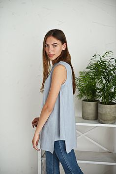 "Loose linen top / Linen blouse with gussets / Linen summer blouse / Sleeveless linen shirt / Linen maternity blouse / Ice blue Comfortable linen cloth hand made from washed linen fabric. The blouse is loose, flare, with two triangular shape insets in sides. You can choose from 16 colors. (The color palette you can find it in the end of listing). Details: - 100% pure Baltic linen; - medium weight linen; - color: ice blue - washed; - simply finished; - handmade; Size: model is wearing size M GENE Linen Summer Tops For Daywear, Summer Linen Tops For Daywear, Linen Sleeveless Blouse For Daywear, Summer Linen Tank Top For Layering, Summer Linen Blouse In Flax Color, Flax Linen Tank Top For Spring, Flax Sleeveless Top For Spring, Sleeveless Flax Tops For Spring, Spring Sleeveless Flax Tops