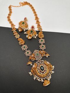 Floral Peacock Design CZ Matte Finish Ethnic Long  Necklace with Screw Back Earrings. Traditional Necklace pair it up with sarees or Lehengas. Perfect for this festive season. Necklace Length : 24 Inches;  Earring Length : 2 Inches Approx. Screw Back Premium quality and craftmanship Ready to ship from Boston, Massachusetts. If you have any questions please let me know. Festive Peacock Design Jhumkas For Puja, Chandbali Peacock Design Temple Necklace For Celebrations, Festive Chandbali Temple Necklace With Peacock Design, Peacock Design Chandbali Temple Necklace For Celebration, Bollywood Temple Necklace With Peacock Design For Diwali, Bollywood Style Temple Necklace With Peacock Design For Diwali, Festive Temple Necklace With Peacock Design For Navratri, Festive Navratri Temple Necklace With Peacock Design, Festive Temple Necklace With Peacock Design For Diwali