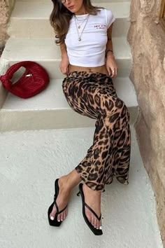 Made from a silky material that hugs you in all the right places, the Leopard Slim Fit Maxi Skirt is a mix of cute and sexy. Dress it up with a pair of kitten heels and a blazer, or dress it down with sneakers and your favorite tee! 95% satin, 5% spandex Slim Fit Low Rise Side Zipper Size Guide in Images! Brown Cow Print Skirt Outfit, Fitted Maxi Skirt, Vintage Leopard, Animal Print Skirt, The Leopard, Hip Dress, All The Right Places, Low Waisted, Skirts For Sale