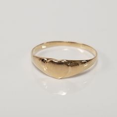 "Thanks for shopping our vintage estate store. We tend to sell well below wholesale and truly hope you enjoy all of our items. Many of the items are one of a kind, so please enjoy scrolling through the pictures and hopefully something will catch your eye. Brown spots are from camera or reflections. Estate 14k yellow gold heart baby ring. Custom made ring for our shop. Ring size: 3.25 Setting: 4mm 1/4\" Band width: 1mm Weight: .59 gram Marked 14k and it's sweet. One that you will love." Classic 14k Gold Heart Ring For Valentine's Day, Classic Heart Ring For Valentine's Day, Classic 14k Gold Heart Engraved Ring, Classic 14k Gold Heart Ring, Classic Gold Engraved Ring For Valentine's Day, Classic Heart-shaped Hallmarked Rings, Classic Engraved Yellow Gold Ring For Valentine's Day, Vintage 14k Gold Heart-shaped Rings, Vintage Yellow Gold Heart Ring As A Gift