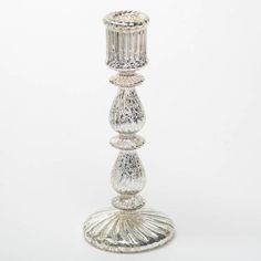 a tall glass candle holder on a white background