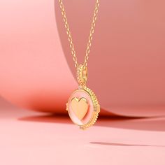 A perfect piece for bringing warmth to your look, the "I Am Loved" necklace will instantly illuminate your day. Made in gold tone sterling silver with pink enamel, set with shimmering rounds and radiant-cut stones, this necklace is designed to help your soul open up and attract passion as the gold heart shines bright around your neck. The engraved words of back will keep you grounded and remind you to love and be loved every time you wear it.Carat Weight: 0.17 ctStone Size: 1.1,2*1 mmStone Type: Pink Gold Plated Necklace For Anniversary, Pink Gold Plated Round Necklace, Feminine Oval Pink Jewelry, Pink Oval Feminine Jewelry, Feminine Pink Oval Jewelry, Pink Gold Jewelry With Clavicle Chain For Gift, Rose Gold Oval Pendant Necklace With Charms, Pink Jewelry With Adjustable Chain For Mother's Day, Pink Clavicle Chain Jewelry For Mother's Day