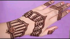 a woman's hand with henna tattoos on it