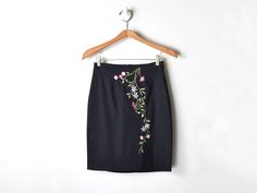 "This vintage Y2K midi skirt has embroidered details. It zips at the back. The tag size is 3 - it measures 26\" around the waist, and 20\" long waist-to-hem. This item is in excellent vintage condition.   Content & Care  - 66% polyester/30% nylon/4% spandex - Dry clean only. - Made in USA. Size & Fit  - Tag size is 3   - Waist: 26\" around    - Length: 20\" long waist-to-hem" Floral Embroidered Fitted Mini Skirt, Fitted Skirt With Floral Embroidery, Fitted Floral Embroidery Skirt, Buttoned Skirt, 2000s Clothing, Skater Outfits, Izod Lacoste, Red Cardigan, Fringe Skirt