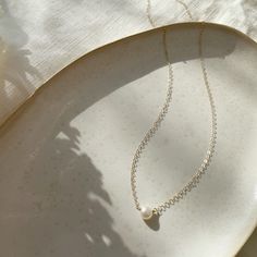 The epitome of classic, the Margot necklace (French for pearl) is a timeless piece to wear on special occasions or for an everyday polished look. Each purchase comes with an elegant, vegan leather box for storing + caring for your jewelry. DETAILS14k Solid Gold | Pearl measures 1/2 mmAvailable in 14", 16" or 18" 14k Gold Clavicle Chain Pearl Necklace For Formal Occasions, Formal 14k Gold Pearl Necklace With Clavicle Chain, Refined Pearl Chain Necklace As Gift, Refined Pearl Chain Necklace For Gift, Dainty Yellow Gold Pearl Necklace For Formal Occasions, Formal 14k Gold Pearl Necklace With Pearl Charm, Refined Yellow Gold Pearl Necklace Gift, Refined Pearl Necklace For Gift, Refined Pearl White Necklace For Gift