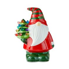 a glass santa clause holding a christmas tree