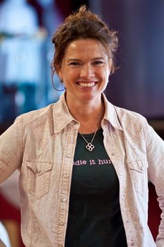 a woman standing with her hands on her hips and smiling at the camera while wearing a t - shirt that says run it everywhere