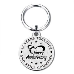 a keychain that says 25 years together happy anniversary and still counting