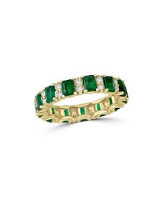 an emerald and diamond ring in yellow gold