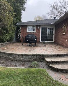 a brick patio with steps leading up to it