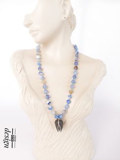 Discover this unique necklace, crafted with a captivating combination of natural beauty and symbolism! This necklace features a blue sodalite stone adorned with an elegant tulip figure pendant. Blue Sodalite is a symbol of inner peace and insight. It promotes both mental and emotional balance and helps you connect with inner wisdom. The tulip figure is a symbol of beauty and grace worldwide. It also represents love, passion, and the beauty of life. Handcrafted, this necklace captures attention w Handmade Sodalite Round Bead Necklaces, Handmade Sodalite Round Beads Necklace, Handmade Kyanite Healing Necklaces, Adjustable Blue Nature-inspired Necklace, Blue Adjustable Nature-inspired Necklace, Handmade Blue Sodalite Necklaces, Handmade Bohemian Kyanite Jewelry, Bohemian Jewelry With Round Sodalite Beads, Bohemian Lapis Lazuli Necklace For Healing