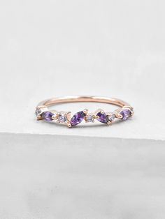 This cluster ring is encrusted with a series of round, oval and pear shaped cubic zirconia stones. The ring is made of gold plated brass. Ring is about 3 mm in height. Stones cover only half of the band. The Cubic zirconias are amethyst colored. This stacker is perfect as a fashionable piece to enhance your outfit or wear as a placeholder for your engagement ring or wedding band! Please read my shop policies to learn more about the composition and proper care for each item purchased. All plated Amethyst Cluster Ring, Purple Promise Ring, Purple Rings Engagement, Engagement Rings Purple, Purple Wedding Ring, Purple Engagement Ring, Amethyst Engagement Rings, Purple Wedding Rings, Purple Engagement Rings