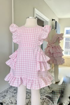 This darling all cotton pink gingham pinafore dress offers loads of ruffles in Carolina Gingham fabric from Robert Kaufman so it's premium cotton and breathable to feel great in the summertime. As is custom with Playful Princess items, the design has our signature flexible fit without fasteners and zippers that may break over time. Adjustable straps loop through the back to tie in a sweet bow. Throw it on over a shirt for a vintage pinafore look during any season. Cute Ruffled Strap Dresses For Picnic, Gingham Dress With Ruffled Straps And Details, Gingham Dress With Ruffled Straps And Ruffles, Sleeveless Gingham Dress With Ruffles, Gingham Dresses With Ruffles For Picnic, Gingham Dress With Ruffles For Picnic, Picnic Gingham Dress With Ruffles, Summer Gingham Plaid Dress With Ruffle Hem, Cotton Gingham Plaid Dress With Ruffles