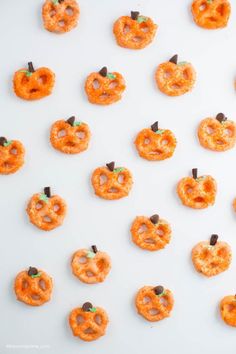 halloween pretzels and jack - o'- lanterns are arranged on a white surface