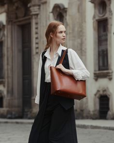 Your quintessential carry-all tote bag gets a sustainable upgrade with our Elba Tote: the durable, all-seasons bag that can take you from the office to the grocery store to a night on the town. Crafted in buttery vegetable-tanned leather that’s kind to the environment, this never-clunky tote can stand on its own, and its double-open pockets are ideal for carrying your notebooks or laptop. Stash your smaller essentials in our accompanying wristlet clutch, which looks elegant worn on its own, and Elegant Cognac Shoulder Bag For Workwear, Chic Bucket Bag With Smooth Grain For Work, Structured Leather Bucket Bag, Smooth Grain Top Handle Bucket Bag For Work, Timeless Structured Shoulder Bag For Daily Use, Classic Everyday Bucket Bag With Smooth Grain, Brown Smooth Grain Bucket Bag For Work, Formal Vegetable Tanned Leather Shoulder Bag, Elegant Leather Bucket Bag For Work