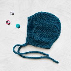 "❤️ 𝗗𝗘𝗧𝗔𝗜𝗟𝗦 This teal winter toddler bonnet hat is perfect for your little one stay warm and stylish through the cold days! A handmade bonnet hat with a simple, yet lovely, pattern that your toddler will love to wear. This kids knit hat closes tightening a bow with the crochet ribbon around your kid's neck. ⭐️ 𝗙𝗘𝗔𝗧𝗨𝗥𝗘𝗦 - Handmade knit bonnet - Season: WINTER - Yarn (100% acrylic) - Colour: pick your favorite color from the \"select a color\" option. The color chart is in the pictures above. - Production Method: Knit - ID number: NGB0574 - Sizes (measure the circumference around the head): 2-3 years: 19-20\" (48-50cm) 3-5 years: 20-20,5\" (50-52cm) 5-8 years: 20,5-22\" (52-56cm) ✈️ MADE TO ORDER: one item has a processing time of 4 to 6 weeks --------------------------------- Handmade Playful Winter Bonnet, Playful Handmade Winter Bonnet, Adjustable Knitted Bonnet, Handmade Winter Bonnet Cap, Handmade Winter Bonnet, Handmade Adjustable Beanie Bonnet, Handmade Winter Bonnet As A Gift, Handmade Winter Bonnet As Gift, Handmade Winter Bonnet Gift