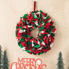 a christmas wreath hanging on the side of a wall