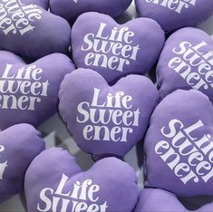 purple heart shaped cookies with white words on them that say life sweetener and star