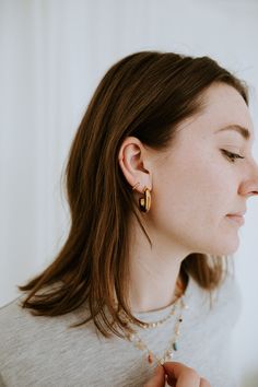 Add a touch of understated elegance with The Mini Dottie Hoops. These delicate hoops are the perfect way to elevate your everyday look with a subtle glimmer. With their tiny, minimalistic design, these hoops provide just the right amount of shine to make a statement while maintaining a light, barely-there charm. The Details - Material: 18K Gold Filled—offering a luxurious gold finish with long-lasting durability and a shine that won’t fade. - Hoop Size: 10mm—small and delicate, providing a refin Delicate Gold-plated Huggie Earrings For Everyday, Delicate Yellow Gold Huggie Earrings For Everyday, Gold Dainty Huggie Earrings For Everyday, Dainty Gold Huggie Earrings For Everyday, Delicate Tarnish-resistant Huggie Earrings For Everyday, Tiny Gold Minimalist Huggie Earrings, Everyday Dainty Gold Huggie Earrings, Delicate 14k Gold Filled Huggie Earrings For Everyday, Everyday Delicate 14k Gold Filled Huggie Earrings