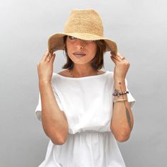 Introducing the Belfry Llina, the ultimate hat for those looking to channel a western, casual style. Made with raffia straw, this packable hat features an adjustable and tieable chinstrap, allowing for versatile wear. FEATURESStyle: Outdoor with Snap-Up BrimMaterial: 100% Raffia Dimensions: 4" Crown, 3" BrimNotes: Brim can be attached to the crown of the hat via snap fasteners on each side. Summer Fedora With Short Brim For Everyday, Casual Everyday Brimmed Straw Hat, Bohemian Beige Straw Hat For Travel, Summer Everyday Toquilla Straw Fedora, Everyday Lightweight Brimmed Straw Hat, Lightweight Brimmed Straw Hat For Everyday, Summer Fedora In Toquilla Straw, Everyday Summer Fedora In Toquilla Straw, Summer Style Natural Fedora For Everyday