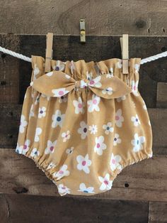 Adorable, comfortable, and soft baby boomer for your precious little love! Made of soft cotton, it is washable and durable for hours of baby fun. This bloomer has a high-waisted ruffle and elastic waistband and leg cuffs. A cute attached bow makes the front sassy and fun! (Not designed for sleepwear) Bloomers are made of 100% cotton (unless otherwise indicated) and are machine washable in warm water. Fabrics were all washed and preshrunk prior to assembly but I would recommend drying on a cool s Cotton Bloomers With Ruffles For Spring, Spring Cotton Bloomers With Ruffles, Summer Cotton Bloomers Short Style, Summer Cotton Short Bloomers, Cute Summer Bloomers, Cute Bloomers For Spring Playwear, Cute Bloomers For Playwear, Spring Season, Cute Spring Bloomers, Playful Short Bloomers For Summer