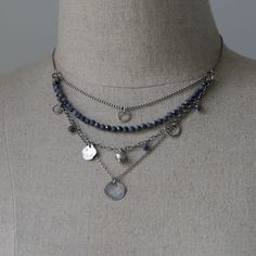 "The Raw Silver and Sapphire Layered Necklace for Women is a stunning piece of handcrafted jewelry. Made with sterling silver and featuring blue sapphire gemstones, this necklace showcases the natural beauty of these materials. The beaded necklace is oxidized and polished, adding depth and charm to the overall design. Its boho style gives it a trendy and fashionable appeal. Layered necklace for women is perfect jewelry gift for sister or wife. Dress up your necklace on special occasion, or send Cheap Silver Layered Jewelry, Cheap Bohemian Silver Layered Necklace, Cheap Silver Layered Beaded Necklace, Cheap Silver Beaded Chain Layered Necklace, Boho Choker Necklace Silver, Affordable Silver Layered Jewelry, Boho Jewelry Silver, Silver Sterling Beaded Gemstone Necklace, Silver Sterling Silver Beaded Gemstone Necklace