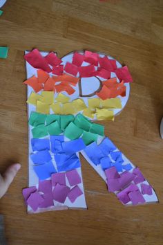 the letter k is made out of colored paper and cut into smaller pieces with scissors