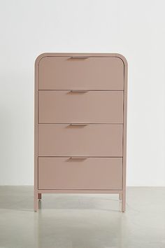 a pink dresser sitting on top of a white floor