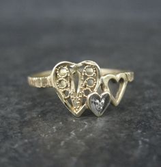 This beautiful, dainty, vintage filigree heart ring is 10k yellow gold with a tiny genuine diamond. The face of this ring measures 5/16 of an inch north to south. Size: 6 Marks: JCM, 10K Condition: Excellent Heirloom 14k Gold Heart Promise Ring, Vintage Promise Jewelry For Valentine's Day, Heirloom Engraved Heart Ring, 14k Gold Heirloom Heart Promise Ring, Vintage Promise Rings With Intricate Design, 14k Gold Engraved Filigree Ring For Anniversary, Vintage 14k Gold Promise Jewelry, Vintage Heart Ring For Promise, Vintage Heart Ring For Valentine's Day Promise