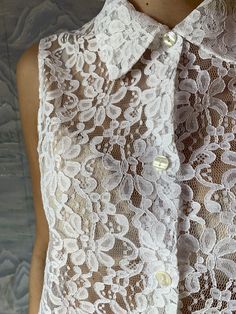 "Ivory White Lace Vintage blouse Sheer Lace Blouse Button Up Summer Blouse Floral Vintage Romantic Bohemian Medium to Large Size N.B. Color may slightly differ from picture. Estimated size: M/L Measurements (laying flat): Bust: 21,5\" / 54 cm Waist: 25\" / 64 cm Length: 28\" / 71 cm Please check measurements to insure a proper fit. Remember to allow yourself some extra room for movement. You can compare these with something from your closet that fits you well. Please convo me if you need additio Spring Wedding Button-up Blouse, Elegant Sleeveless Blouse With Button Closure, Elegant Beige Sleeveless Blouse, White Feminine Collared Blouse, Fitted Sleeveless Blouse With Button Closure, Elegant Collared Tops With Pearl Buttons, Elegant Button-up Blouse With Pearl Buttons, Lace Button-up Top, Feminine Blouse With Button Closure And Collar