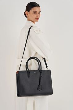 [vc_row][vc_column width=”1/3″][vc_column_text text_larger=”no”] Oroton Women’s Muse 15″ Worker Tote   Oroton Muse 15″ Worker Tote The Oroton Muse 15” Worker Tote and Pouch in black is crafted from a double textured leather. It combines both saffiano and smooth calf leather, to create a luxurious day-bag. Internally the laptop bag has 5 main compartments, a removable laptop pouch and an internal zip pouch and slider pocket. Fitted with two griptop h Modern Textured Leather Briefcase For Work, Modern Black Saffiano Leather Briefcase, Black Saffiano Leather Briefcase For Work, Black Textured Leather Briefcase For Work, Elegant Textured Leather Laptop Bag For Work, Black Saffiano Leather Bag For Work, Black Epsom Leather Bag For Work, Black Smooth Grain Briefcase For Everyday Use, Everyday Black Briefcase With Smooth Grain