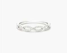 14K White Gold Petite Open Infinity Diamond Ring. The infinity design is a timeless classic perfect for everyday wear, and the open weave lends added elegance to this petite design. Crafted in 14K gold, this piece is beautiful worn on its own or with other stackables for a trendier look. Elegant Infinity Diamond Ring For Formal Occasions, Elegant Stackable Diamond Ring, Elegant Stackable Infinity Rings, Elegant Half Eternity Infinity Rings, Elegant Infinity Eternity Band For Anniversary, Elegant Infinity Diamond Ring With Accents, Elegant Infinity Half Eternity Rings, Elegant Infinity White Gold Rings, Elegant White Diamond Ring With Open Band