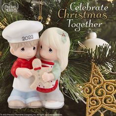 a christmas ornament with two children hugging each other in front of a tree