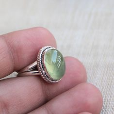 Gemstone - Natural Prehnite Gemstone Size - 10x14 mm oval Metal - Sterling Silver Ring size - All sizes available Each Ring made with Precision and love, these rings are perfect for everyday use and a perfect accessory to wear at work. Rings can be customized on request and gemstone can be switched to any other as per requirement. Same design also uploaded with Amethyst, Aqua Chalcedony, black star diopside, Citrine, Carnelian, Crystal Quartz, Golden rutile quartz, Lapis Lazuli, Labradorite, Mal Oval Cabochon Emerald Ring Gift, Oval Cabochon Rings For May Birthstone, Adjustable Green Oval Opal Ring, Green Oval Prehnite Rings, May Birthstone Rings With Natural Stones, May Birthstone Oval Rings With Natural Stones, Oval Natural Stone Ring For May Birthstone, Oval Rings With May Birthstone And Natural Stones, Oval Natural Stones Ring For May Birthstone