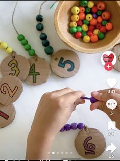 someone is making wooden numbers with beads on the table