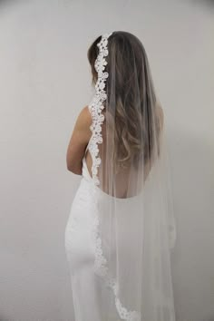 the back of a woman wearing a wedding veil