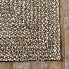 an area rug on top of a wooden floor with a wood floor in the background