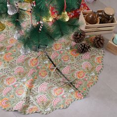 a christmas tree skirt with pine cones and candy canes