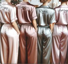 three women in matching satin pajamas standing next to each other with their names on them