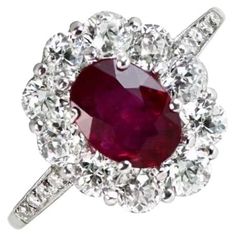 Edwardian-inspired Natural Oval Ruby Ring featuring a 1.05-carat oval-cut natural ruby surrounded by a halo of old mine-cut diamonds in a floral head motif. Pave-set diamonds adorn the shoulders. The total diamond weight is around 1.50 carats. This Natural Oval Ruby Ring is Crafted in platinum with openwork under the gallery. Ring Size: 6.5 US, Resizable Metal: Platinum Stone: Diamond, Ruby Stone Cut: Oval Cut Style: Edwardian Total Weight: 3.83 Grams Oval Ruby Ring, Engagement Ring Halo, Oval Cut Engagement Ring, Ruby Engagement Ring, Oval Rings, Ruby Stone, Halo Engagement Rings, Ruby Ring, Stone Cuts