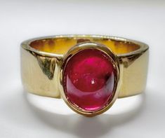 This antique handmade designer ruby ring is a unique piece of jewelry that is perfect for any occasion. The ring is made of brass and is gold plated. The main stone is a natural ruby that is oval in shape and measures 10mm in length and 8mm in width. The gemstone clarity grade is eye clean and the cut grade is excellent. The bezel setting style is used to secure the ruby. The ring is a size 7 US and can also be customized to fit the customer's wants. Personalization is available and the design o Antique Style Rings, Gold Plated Rings, Handmade Gold, Men's Ring, Ruby Ring, Natural Ruby, Ring Jewelry, Ring Handmade, Antique Style