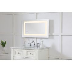 a bathroom vanity with two sinks and a large mirror above it, in front of a white wall