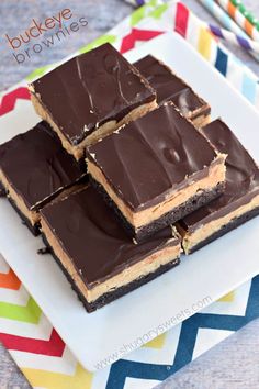 four pieces of chocolate peanut butter brownies on a plate