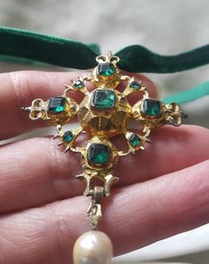 I always maintain that a cross is a dramatic piece of jewellery. This one is high grade silver (unmarked and tested) and is gilded in gold. The pendant is 2 1/4 inches long by 1 3/4 inches wide. It is beautifully designed with emerals green flat cut pastes and had a pearl drop. The bubble back it typical of this period and the gold gilding has worn with centuries of wear. The center stone is cracked but appears to be stable. C. 1720 and Spanish. Follow me on instagram2jettesjewels. Hallmarked Cross Pendant Jewelry For Formal Occasions, Antique Cross Pendant Necklace As Gift, Antique Cross Pendant Necklace For Formal Occasions, Formal Cross Pendant Necklace With Large Pendant, Formal Necklace With Large Cross Pendant, Antique Cross Jewelry For Formal Occasions, Ornate Cross Pendant Jewelry For Formal Occasions, Antique Cross Jewelry For Wedding, Formal Cross Pendant Jewelry